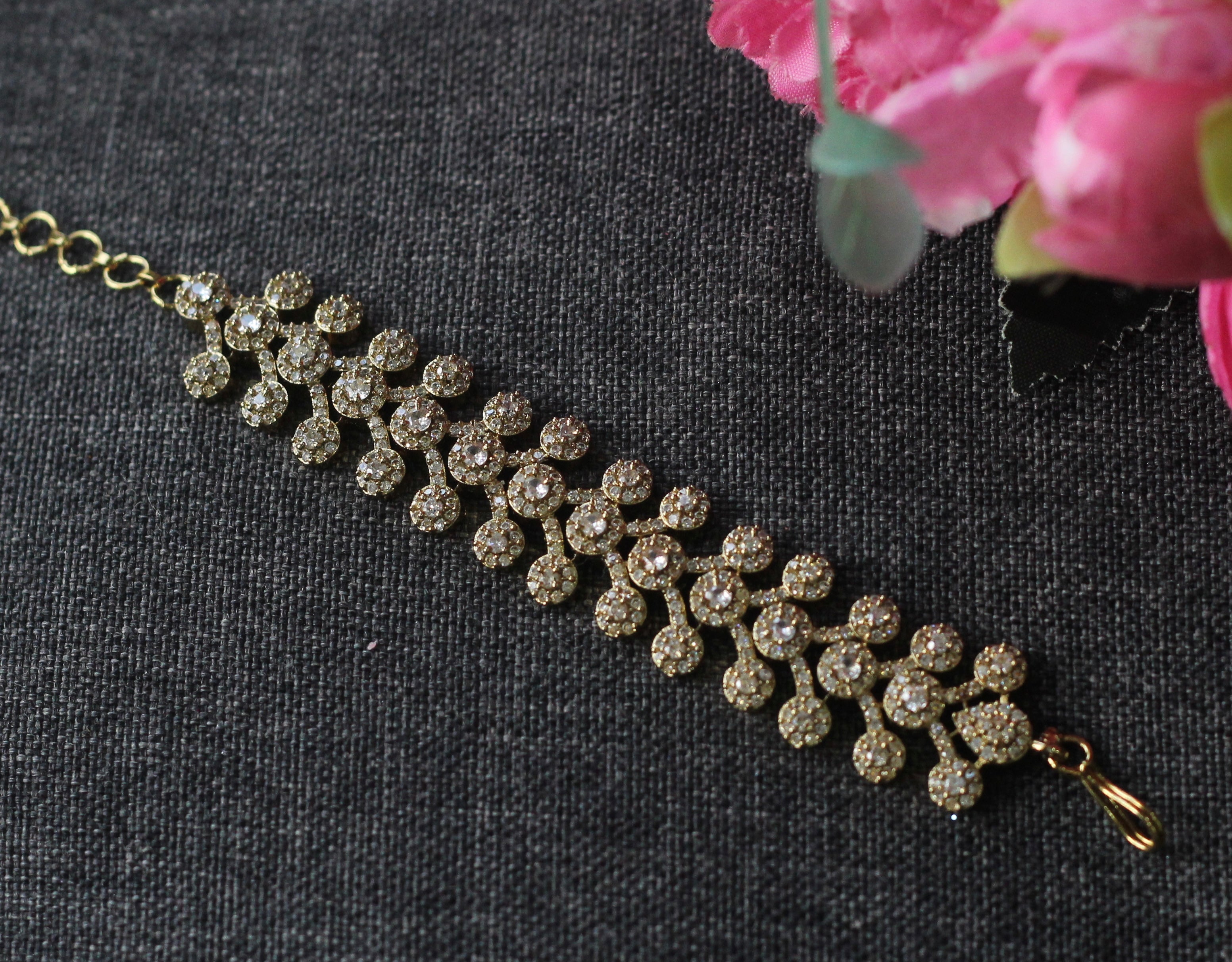 A gold-plated bracelet adorned with clear pavé rhinestones