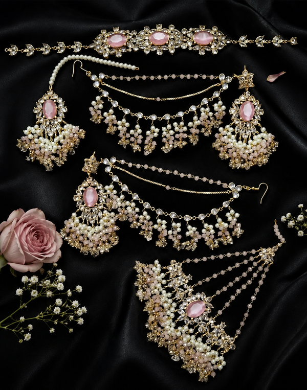 A gold-toned Indian bridal jewelry set with pink stones and white faux pearls.